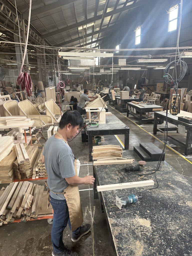 Factory workers hand-crafting furniture on the production floor