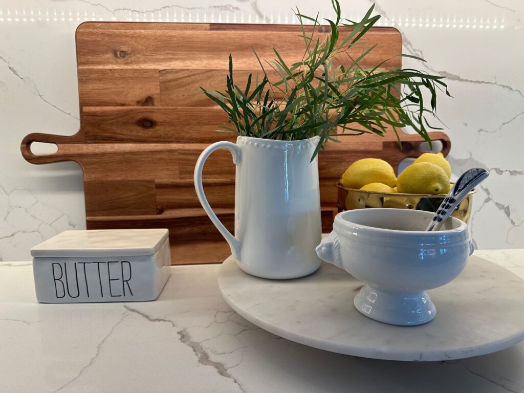 Styled console with vintage art and collected objects